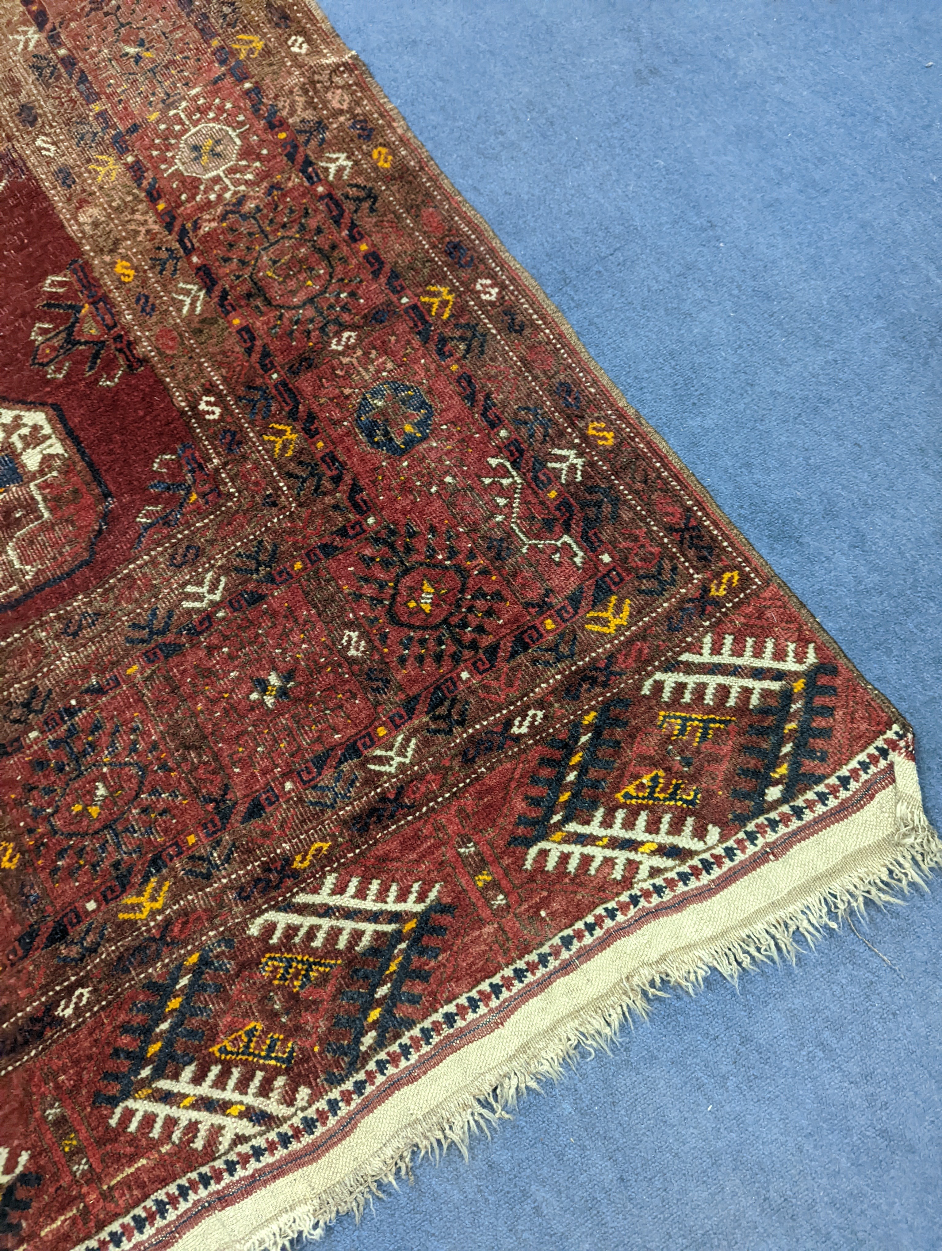 A Bokhara red ground rug, 200 x 114cm